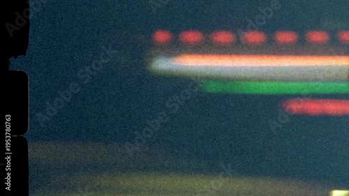 Super 8mm vintage abstract traffic lights streak across the screen at night