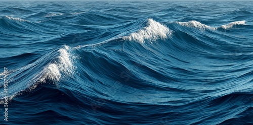 Deep blue ocean waves with white foam, creating a dynamic and textured water surface, perfect for backgrounds and nature themes.