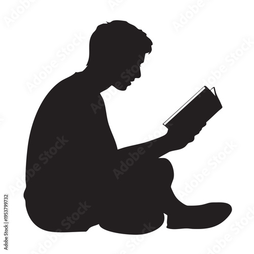 A man sits cross-legged reading a book in a quiet moment of leisure and relaxation indoors.