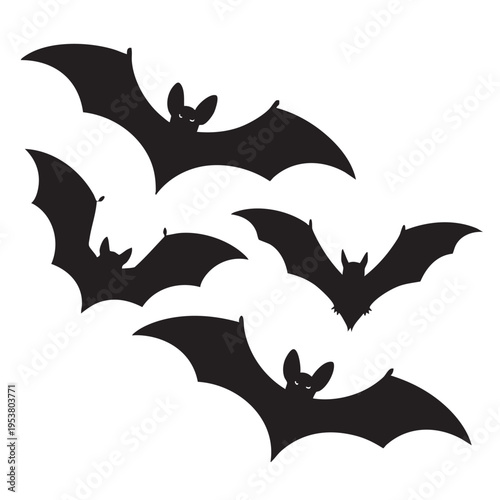Three black bats flying together in the dark evening sky with wings spread wide