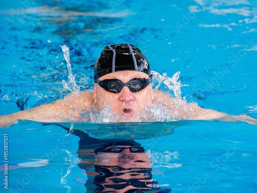 A swimmer using breaststroke in a swimming pool, close-up