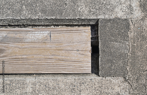 Timber Plank Inset into Old Concrete Wall in Close Up 