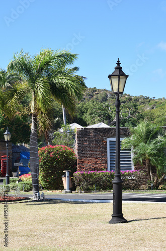 Traditional Cast Iron Street Light on Lawn of Old 18th Century Building in the Caribbean 