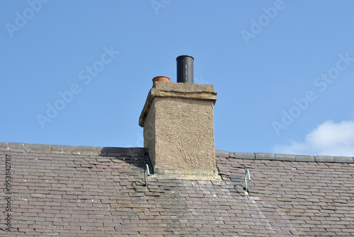 Chimneys and Chimney Stack on Old Victorian House with Slate Roof Covering 