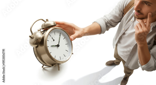 Man holding vintage alarm clock with thoughtful expression