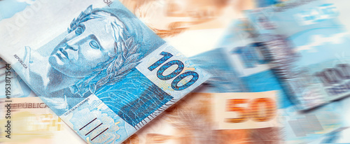 Brazilian money, in pinpoint focus, one hundred reais banknotes for journalistic background or promotions, concept of jackpot, draw or payment