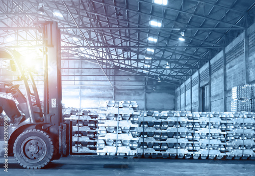 Photos Yellow Forklift Carrying Aluminum Ingot Bundles in Storage Facility
