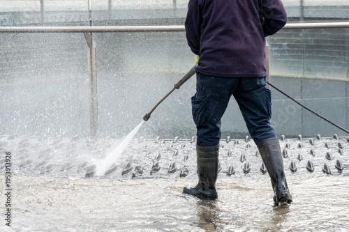 Wallpaper Mural Worker cleaning outdoor surface using water pressure washer Torontodigital.ca