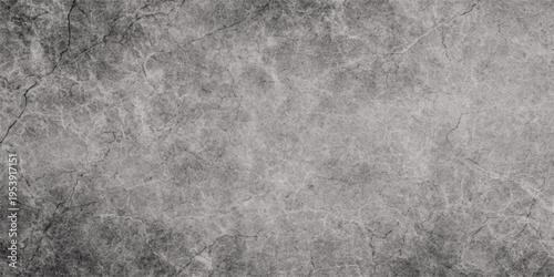 A dark grunge stone wall texture featuring an aged grey concrete surface with a rough vintage pattern for a textured black and white wallpaper backdrop