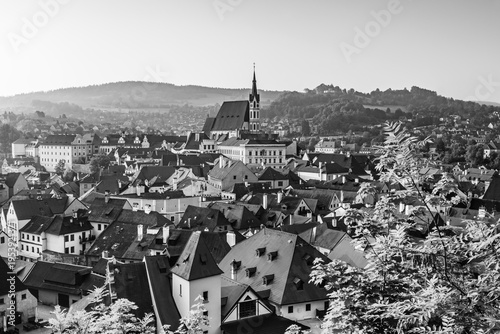 A stunning aerial drone view of Cesky Krumlov in the Czech Republic, showcasing its historic old town, red rooftops, and the winding Vltava River. This UNESCO World Heritage site features picturesque 