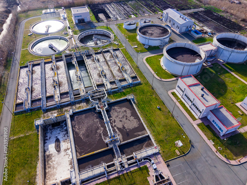 Canvas Print View of a water treatment facility with several large tanks and buildings shown