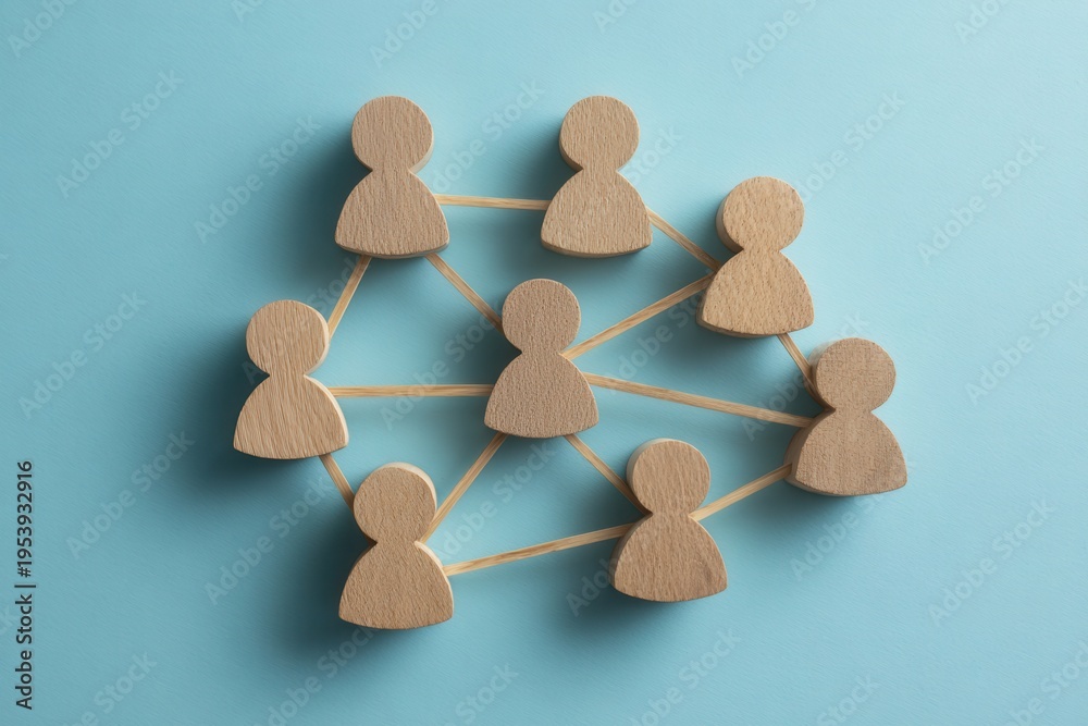 Obraz premium Human Network: A network of wooden figures connected by lines on a blue backdrop, symbolizing collaboration and community.