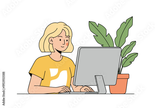 Young female professional working on desktop computer at office desk