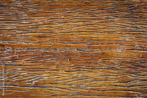 The surface of the wood has a cracked pattern and is coated with lacquer. Background, Abstract, Backdrop.