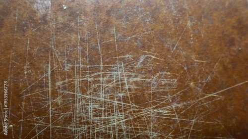 Fotografía Close-up of scratched wooden surface with intersecting marks revealing lighter t