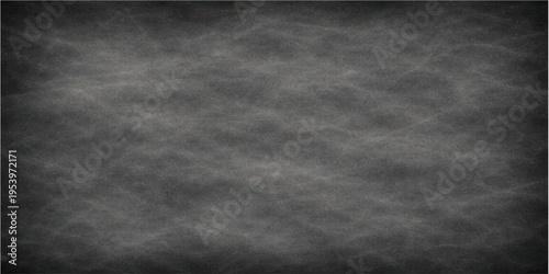 A weathered blackboard serves as a blank canvas, its textured surface hinting at a history of lessons and ideas, ready for new beginnings.