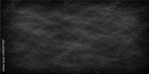 A textured, blank chalkboard, ready for creative expression or educational use, captures the essence of a traditional classroom tool, with its rough surface offering a tangible tactile sensation.