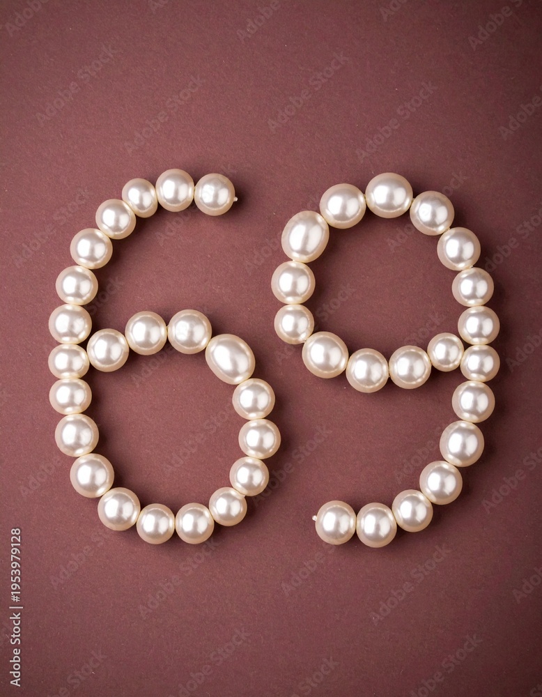 Obraz premium Number 69 made out of small pearls on a neutral solid background
