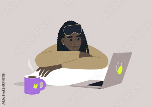 Nestled under soft blankets, a person enjoys a relaxing evening with a laptop, a warm cup of tea, and a cozy atmosphere, fully immersed in the digital adventures ahead.