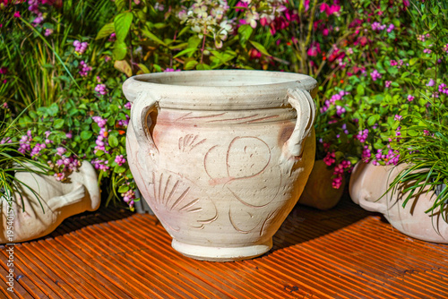 Large handmade Tunisian clay planter with handles in garden