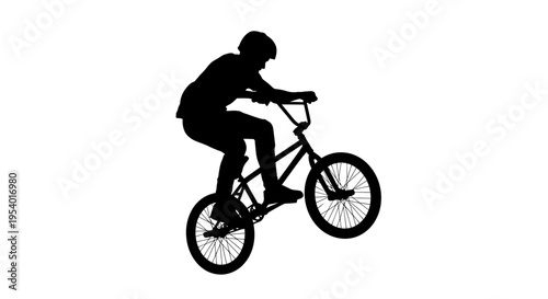 Silhouette of a BMX Rider Performing a Wheelie Trick