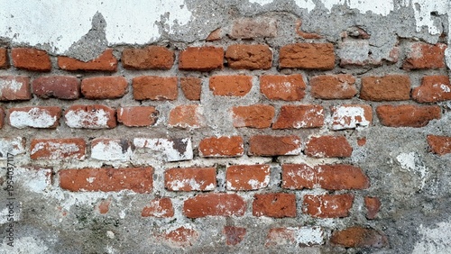 Old brick wall background texture with weathered red bricks and peeling white paint, close up architectural detail of rustic masonry for urban decay concepts and vintage construction design projects.