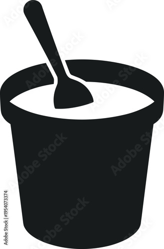 Black container with a spoon holding a creamy substance inside