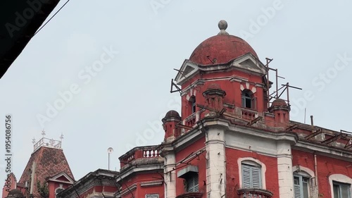 A red-coloured, British-era building called Chowringhee mansion in Park Street, Kolkata