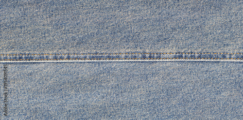 Blue jeans fabric with orange seam and texture