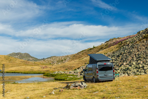 Camper van wild camping near mountain lake in Piedmont