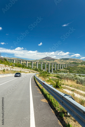 Konstfotografi Driving car on rural road near viaduct Agnone Italy