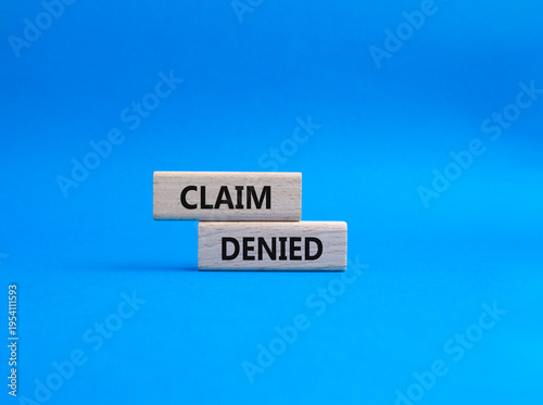 Claim denied symbol. Wooden blocks with words Claim denied. Beautiful blue background. Business and Claim denied concept. Copy space.