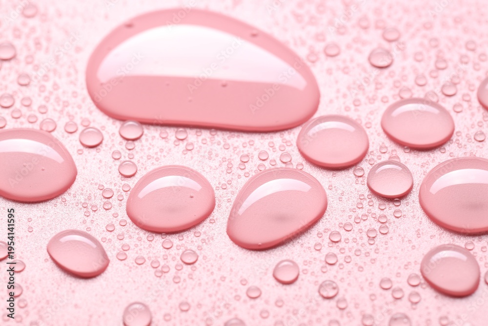 Fototapeta premium Many water drops on pink background, selective focus