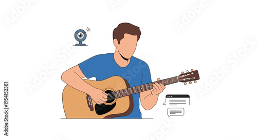 A man in a blue t-shirt sits and plays an acoustic guitar with a webcam nearby.