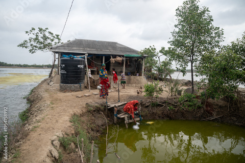 Satkhira, Bangladesh - 25 April 2025: View of a humble dwelling teetering on the edge, where life persists amidst the encroaching waters, a testament to resilience.