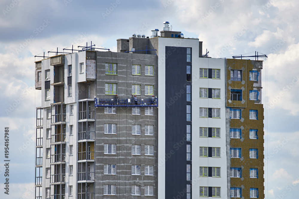 Fototapeta premium The process of insulating a modern multi-story building.