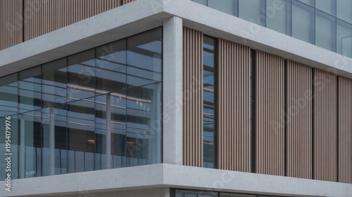 Architectural corner of a modern office building displays mixed materials and structural glass for urban business branding.