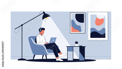 Professional man wearing headphones sitting in armchair working on laptop in stylishly decorated living room.