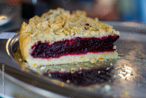 Canvas Print Slice of berry pie with crumble topping, rich red filling and soft pastry layers