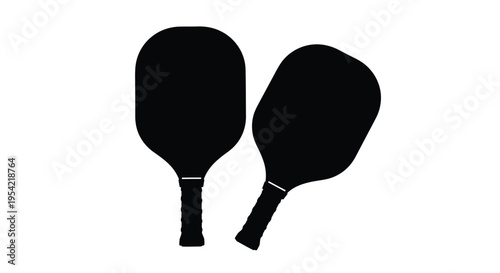 Two pickleball paddles displayed against a white background a dark silhouette