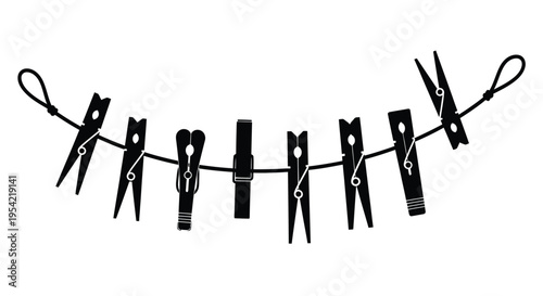 Clothes pins hanging on a line a striking black graphic silhouette