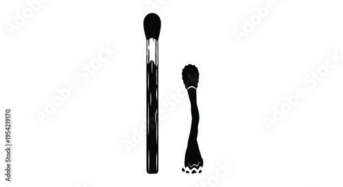 Two makeup brushes displayed in a striking black silhouette