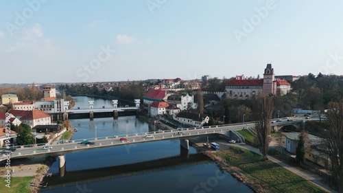 Aerial drone rising shot of road bridge over Elbe river with historic castle and town, Brandýs nad Labem, Czech Republic