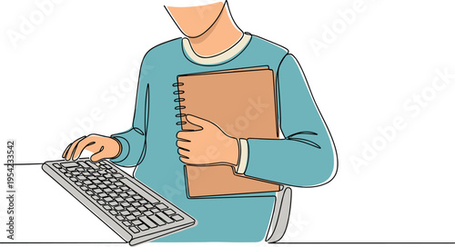 A person is working on a computer while holding a notebook
