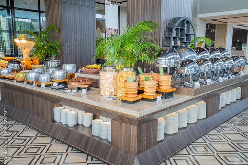 Fotografie Luxury hotel buffet featuring Indonesian snacks, fruits, and hot dishes in a modern restaurant interior, highlighting premium self service dining and hospitality experience