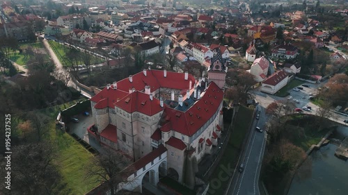 Aerial drone orbit around Brandýs nad Labem castle showing entrance bridge and moat, Czech Republic