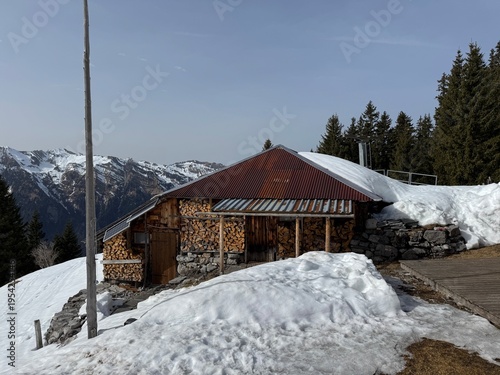 Old traditional swiss rural architecture and alpine livestock farms in the winter ambience of the alpine Swiss tourist resort Davos - Canton of Grisons, Switzerland (Kanton Graubünden, Schweiz)