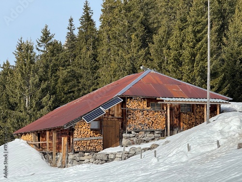 Old traditional swiss rural architecture and alpine livestock farms in the winter ambience of the alpine Swiss tourist resort Davos - Canton of Grisons, Switzerland (Kanton Graubünden, Schweiz)