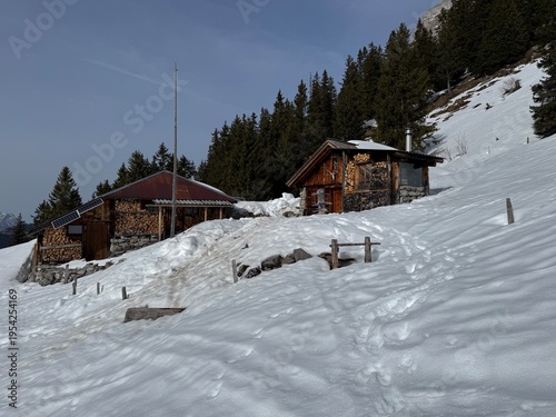 Old traditional swiss rural architecture and alpine livestock farms in the winter ambience of the alpine Swiss tourist resort Davos - Canton of Grisons, Switzerland (Kanton Graubünden, Schweiz)