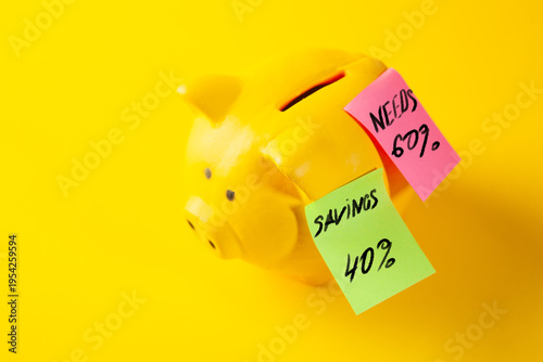 Piggy bank with sticky notes on a yellow background, saving money concept